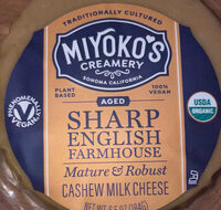 Semi firm aged sharp english farmhouse cheese wheel made from plants, sharp english farmhouse