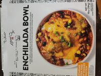 A corn tortilla layered in between riced cauliflower, black beans and veggies topped with enchilada sauce and cheddar cheese enchilada bowl